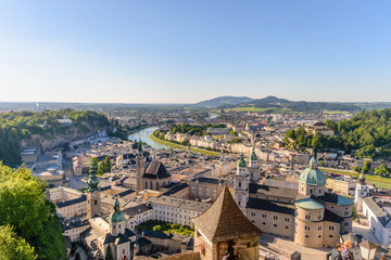 Fototapeta na wymiar The Franciscan Church, Salzburg Cathedral and Stift St. Peter Salzburg in Salzburg over the banks of Salzach river as seen from Fortress Hohensalzburg