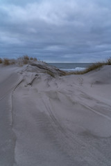 Fototapeta na wymiar sand dunes at sea on a cold autumn evening