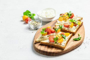 Cherry tomatoes goat cheese sandwiches. Selective focus, copy space.