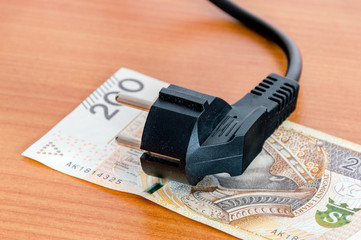 Black power plug on Polish 200 banknote.
