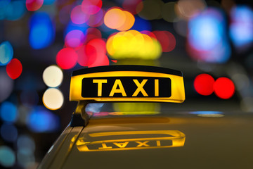 Taxi sign at night.