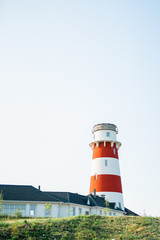 Lighthouse with house on the blue skies background