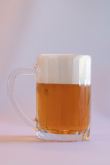 glass of beer with foam isolated on white