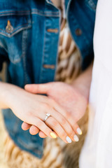Hands of bride and groom with ring on finger