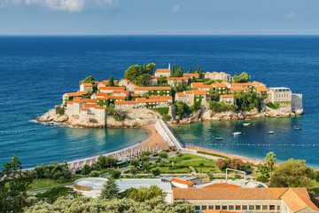Sunny morning view of Sveti Stefan Island near city of Budva, Montenegro.