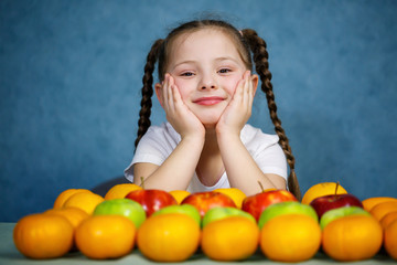 Fototapeta na wymiar Little girl in white T-shirt love fruit
