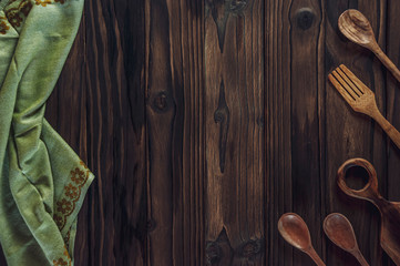 Wood background with napkin and wooden cutlery
