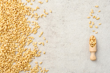 Organic pine nuts, pine nuts in bowl. Flat lay, top wives, copy space.