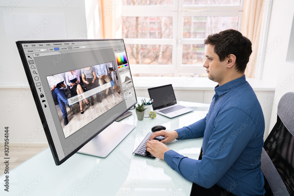 Poster Designer Editing Photo On Computer