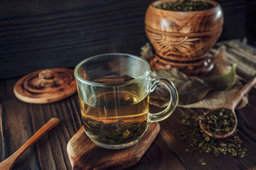 A cup of medicinal soursop tea with dried soursop leaves.