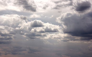 Fototapeta na wymiar huge cumulus rain clouds and clouds in the sky in the sunshine above the field