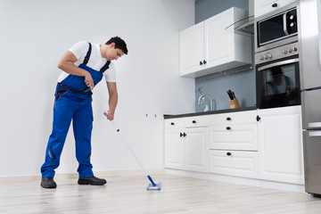 Man Cleaning Floor With Mop