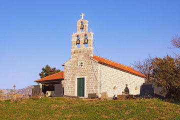 Fototapeta na wymiar Religious architecture. Small village church. Montenegro, Tivat. Orthodox Church of Saint Ivan in Bogisici village