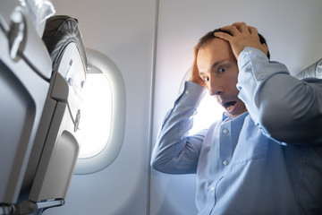 Man Having Anxiety Attack In Airplane