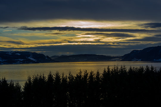 Sunset on a cloudy day over the fjord
