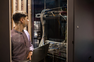 Photo with relfections  in the server room a technician/ It engineer/