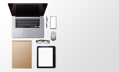 Office desk table with laptop, smart phone, cup of coffee and supplies, isolated on white background. Top view with copy space, flat lay.