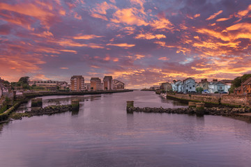 Fototapeta premium River Ayr in the Historic Ancient Town of Ayr in Scotland and a spectacular sunset over the River that Runs through the Town.