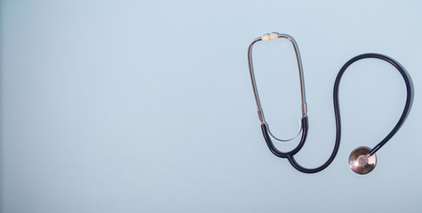 Medical stethoscope or phonendoscope  isolated on light blue background. Close-up of a stethoscope. flat lay. your text here