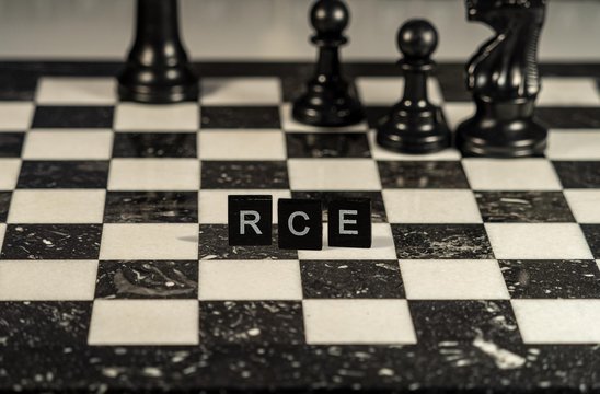 Rce the word or concept represented by black and white letter tiles on a marble chessboard with chess pieces