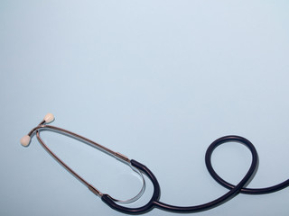 Medical stethoscope or phonendoscope  isolated on light blue background. Close-up of a stethoscope....