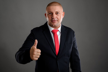 Businessman showing thumbs up