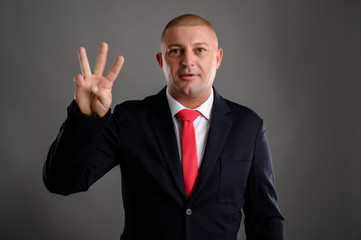 Businessman showing number three