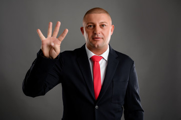 Businessman showing number four