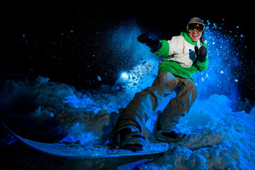 Male in green jacket rides on a snowboard