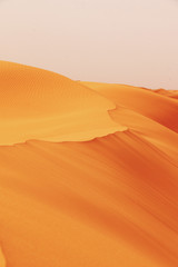 Fototapeta na wymiar Sand dunes desert Background - Beautiful Arabian desert
