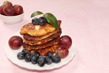 Pancakes with berries, strawberries and grapes, on a sunny sunny background. The concept of healthy and natural food. Healthy breakfast, food for children. selective focus.  Shrovetide