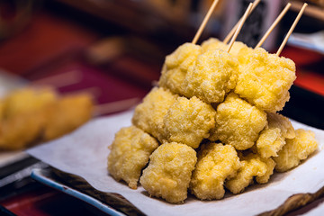 Display of tempura snack with breading crust on skewer in traditional Japanese street food in Nishiki market