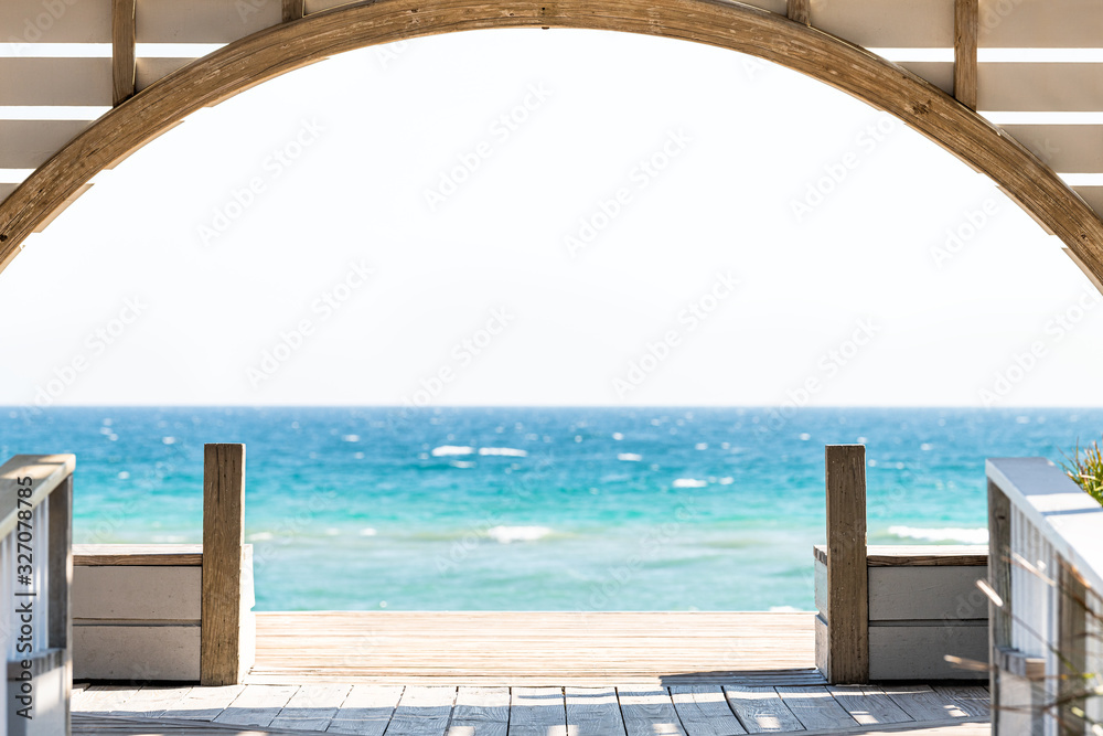 Wall mural seaside, florida framing of wooden pavilion gazebo architecture by beach ocean background view durin - Wall murals