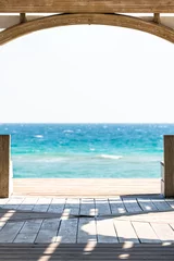 Crédence de cuisine en verre imprimé Descente vers la plage Seaside, Florida frame of wooden pavilion gazebo architecture by beach ocean background view during sunny day