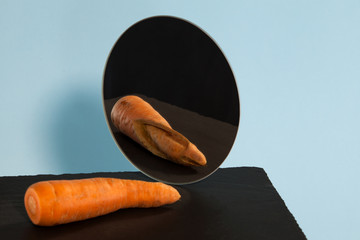Ugly carrots. Reflection in the mirror. Concept-low self-esteem. Copy space