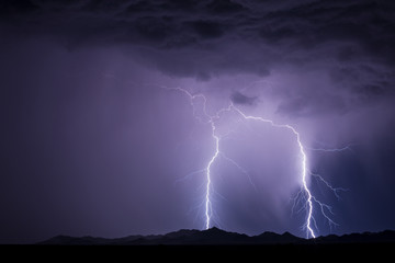 Naklejka na ściany i meble Lightning bolts strike from a thunderstorm