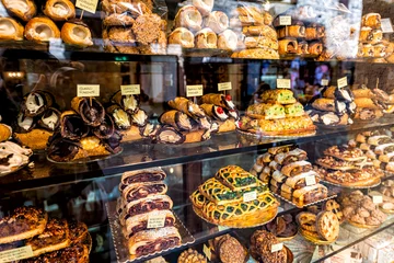 Pastry bakery store shop in Assisi, Umbria Italy selling dessert chocolate cannoli, rocciata cakes and pies with price tags through retail display glass window © Andriy Blokhin