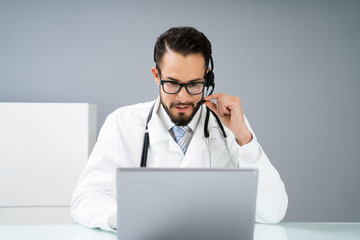 Confident Receptionist Using Headset In Hospital