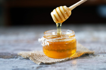 Honey in a jar. Stick for honey. Healthy sweetness. Beekeeping product.