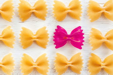 raw Italian pasta Farfalle - abstract vision be different, unique personality or standing out from the crowd, leadership quality. beautiful still life background