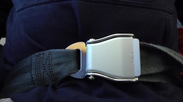 Plane passenger unfastens his seatbelt