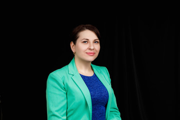 Studio close up portrait of a girl of Slavic appearance worn a blue blouse and a blue-green jacket...