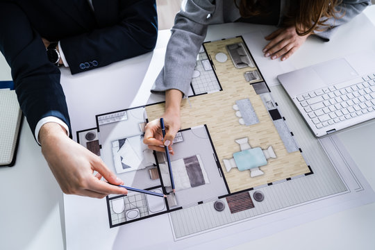 Two Architects Discussing Blueprint