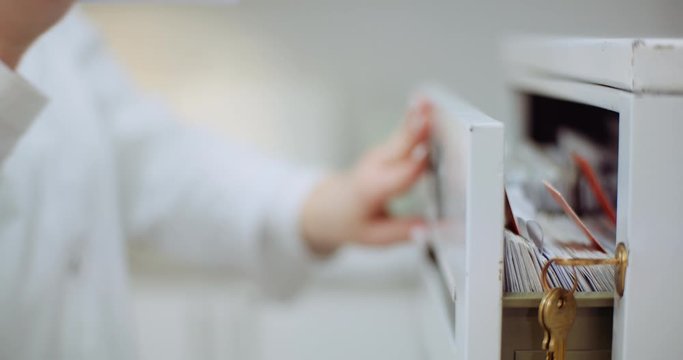 female doctor looks for personal data in the file
