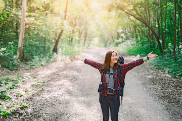 back of wanderlust Asian women tourist hipster backpack to travel and rise hand in green wild forest trip hiking outdoor vacation make a journey holiday,nature lifestyle, Traveler hike concept
