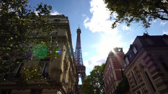 Low angle view of Eiffel tower in Paris. Famous tourist attraction landmark in Paris. Romantic honeymoon travel destination in France.