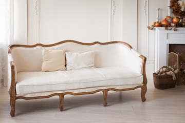 White sofa with fabric upholstery in a room with wooden floor 