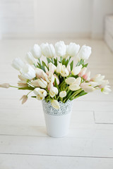 Bouquet of tulips on the window. Beautiful and comfort morning. Sunny day. Decoration of home interior