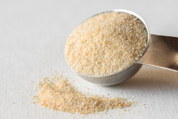 Onion Powder Spilled from a Teaspoon