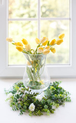 Bouquet of yellow tulips on the window. Beautiful and comfort morning. Sunny day. Decoration of home interior